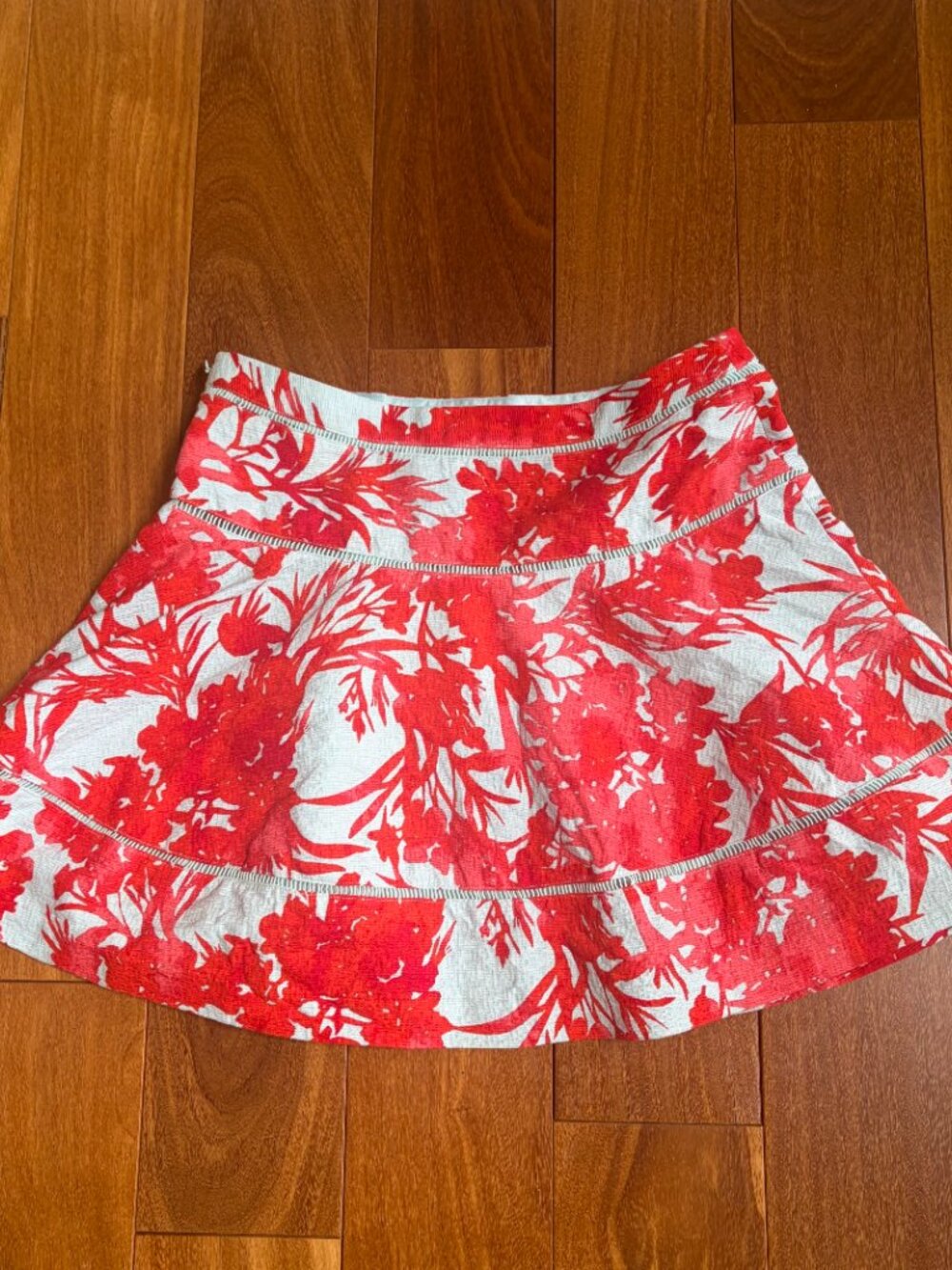 Banana Republic A-line skirt with a vibrant red floral print on a light blue bac